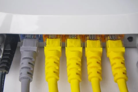 Extreme close-up of a white router's back panel with one grey and four yell.. Stock Photos