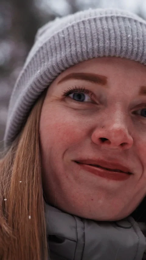 Extreme close-up of womans face in gray knit beanie smiling softly Stock Footage 318194930