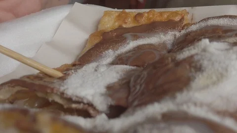 Extreme close up of wood stick pick a slice of delicious freid pancake Stock Footage 112159909