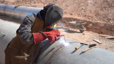 Extreme Close-Up of Worker Arc Welding Metal Pipeline Construction with Audio Stock Footage 334951109