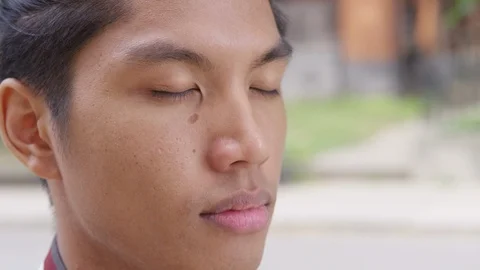Extreme Close up - Young attractive man looks away from the camera with his eyes Stock Footage 125205641