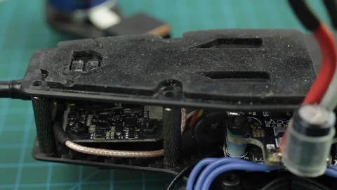Extreme close up of young man's hands assembling FPV racing drone using Stock Footage 128819017