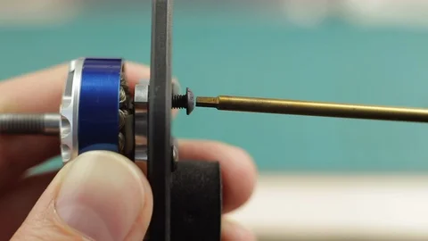 Extreme close up of young man's hands assembling motor of FPV racing drone using Stock Footage 128819100