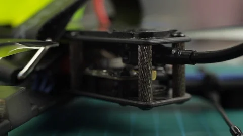 Extreme close up of young man's hands assembling FPV racing drone using Stock Footage 128819225