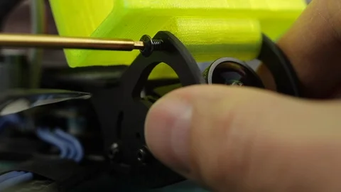 Extreme close up of young man's hands assembling FPV racing drone using Stock-Footage 128820072