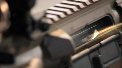 Extreme Closeup of Assault Rifle Ejecting Spent Ammunition Round Stock Footage 41455299