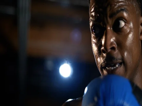 Extreme closeup of boxer's face as he throws punches Stock Footage 83375498