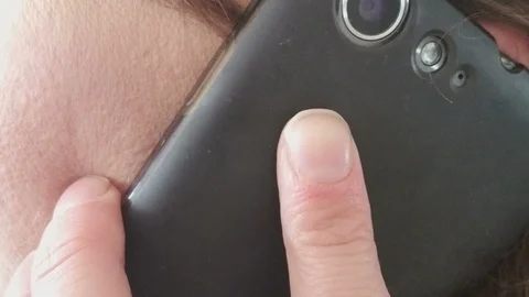 Extreme CloseUp of Cellular Phone Held to Ear and Then Removed Stock Footage 87026722