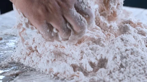 Extreme closeup of hands one by one kneading the pieces of dough in the flour 스톡 동영상 111289248