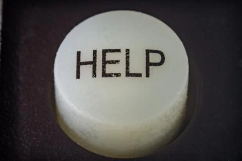 Extreme closeup of a help button on a remote Photos