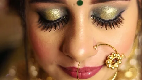 Extreme Closeup of Indian Bride opening eyes and smiling  in door with lighting Video stock 135377989