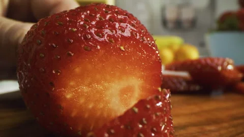 Extreme closeup of knife cutting through juicy strawberry Stock Footage 341238095