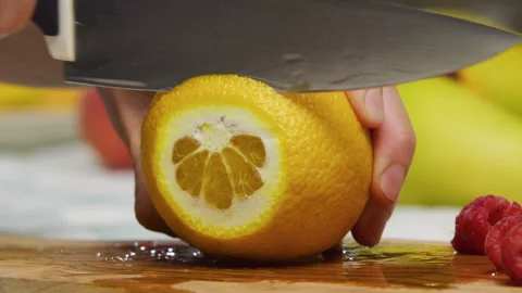 Extreme closeup of knife slicing through juicy orange Stock Footage 341272248