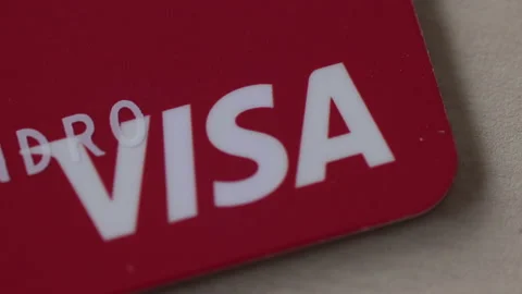 Extreme closeup macro of a Visa red card. Consumerism spending or debt concept Stock Footage 164779274