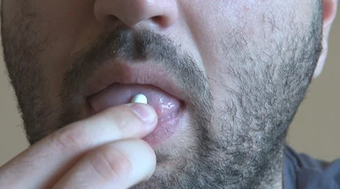 Extreme closeup man face taking white pill, mouth view swallowing pills, illness Stock Footage 49734154