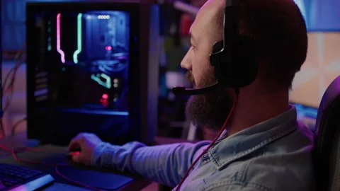 Extreme closeup of man using headset talking into microphone with team while Stock Footage 193929755