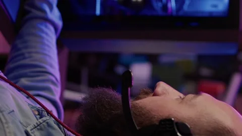 Extreme closeup of man using headset talking into microphone with team while Stock Footage 195818699