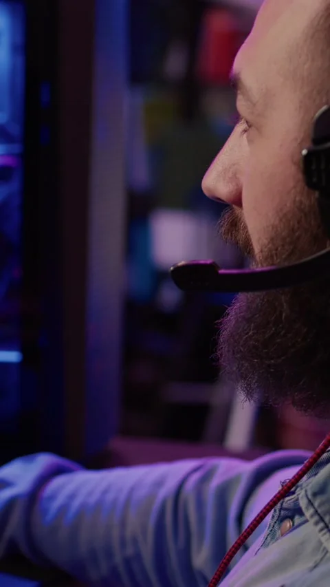 Extreme closeup of man using headset talking into microphone with team while Stock Footage 201069375
