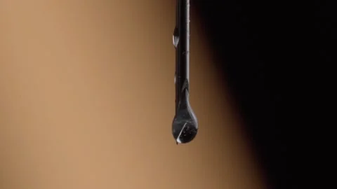 Extreme Closeup of Metal Drill Bit With Water Droplet on Tip in Macro View Stock Footage 340804467