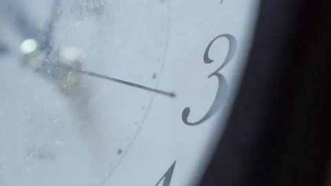 Extreme closeup of metallic second arrow passing by on white clock face Realtime Stock Footage 214017478