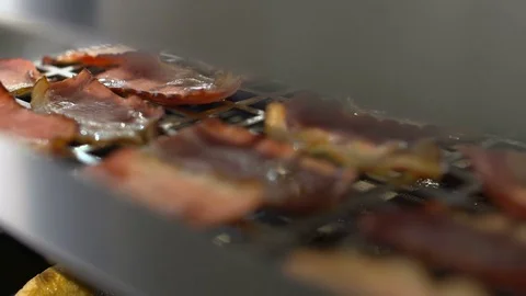 Extreme closeup pan of bacon  on a griddle Stock Footage 82607262