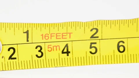 Extreme closeup pan of a yellow tape measure Stock Footage