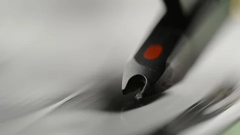Extreme closeup of record player showing needle on record - black vinyl spinning Stock Footage 104530442