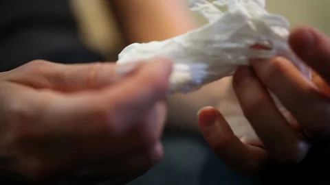 Extreme closeup of restless hands fidgeting with a tissue Stock Footage 97962687