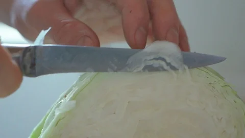 Extreme closeup slow motion man Cutting Cabbage With A Cleaver Knife for a Stock-Footage 123895061