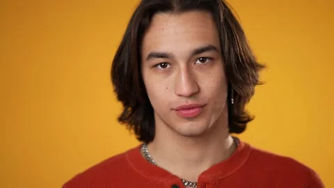 Extreme closeup slow motion portrait of serious gender fluid Latino Hispanic Video stock 220720165