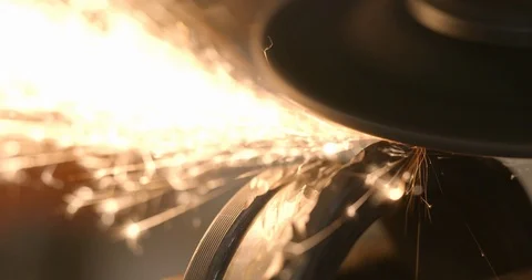 Extreme closeup steel worker with angle grinder making hot glowing sparks Видео 120618757