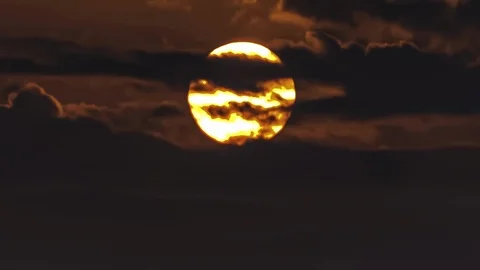 Extreme Closeup Of The Sun Setting Behind The Clouds Video stock 114133772