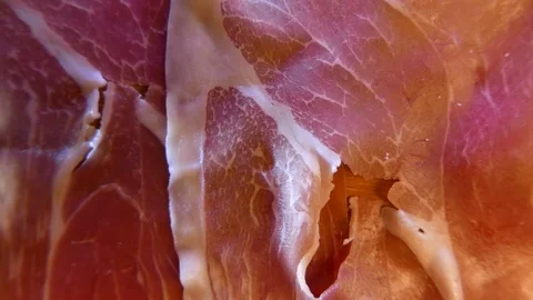 Extreme closeup of thin slices of delicious pork ham on the dish. 4K UHD 库存影片 73047880