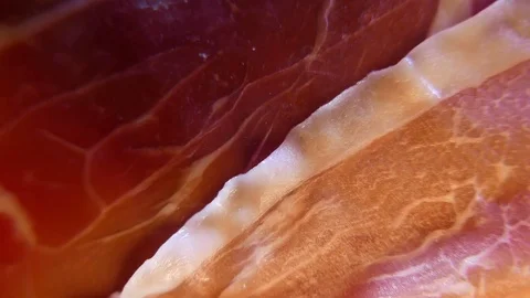 Extreme closeup of thin slices of delicious pork ham on the dish. 4K UHD Stock Footage 73047945
