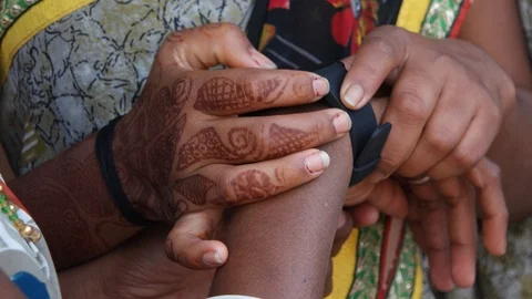Extreme closeup of two Indian hands with henna and colorful sari and fabric  Stock Footage 92718252