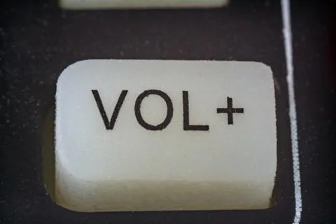 Extreme closeup of volume button on TV remote 写真素材