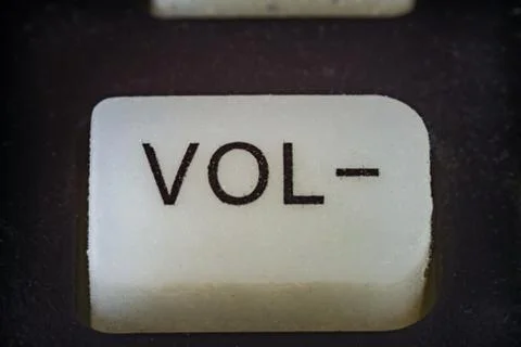 Extreme closeup of volume button on TV remote 写真素材