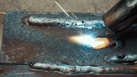 Extreme Closeup of Welding Bead Forming on Steel Plate inside Factory 4k Stock Footage 336711854