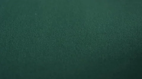 Extreme CU of pair of jacks being dropped on green felt table Stock Footage 53235570