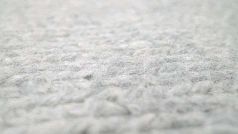 Extreme detail view of sheep wool cloth texture flowing in macro