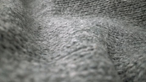 Extreme detail view of sheep wool cloth texture flowing in macro