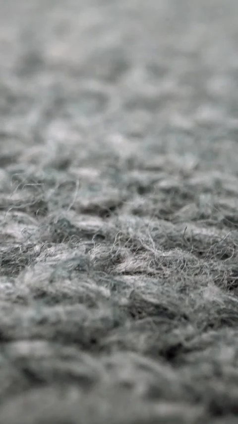 Extreme detail view of sheep wool cloth texture flowing in macro dolly shot. Stock Footage 292431162