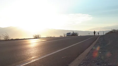 Extreme endurance runner jogs alongside hot road asphalt in death valley Stock Footage 109475232