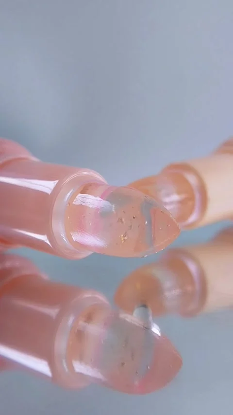 Extreme front close up of two lip balm products with transparent tips. Clea.. Stock Footage 340197593
