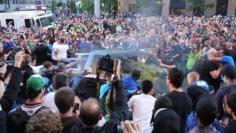 Extreme group behavior as bad crowd of sports fans swing a vehicle Stock Footage 127201709