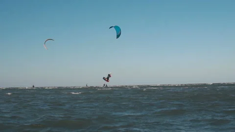 Extreme Kite Boarding Trick Over Camera In Sea. Young Man Kitesurfing in sea Stock Footage 120643232