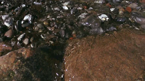 Extreme Long Tracking Shot Along River With Stones In The Water Video stock 37207892