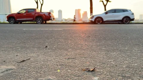 Extreme low angle closeup of asphalt road surface with motorcycle and car Vidéo 341543199