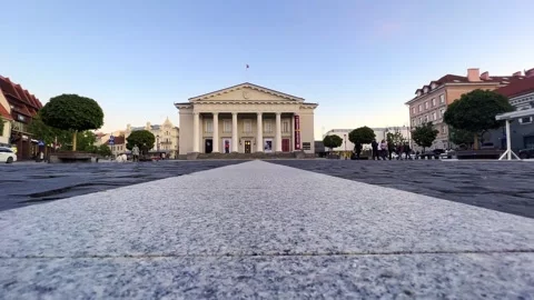 Extreme low angle pov of town hall square with lithuanian flag Stock Footage 280695327