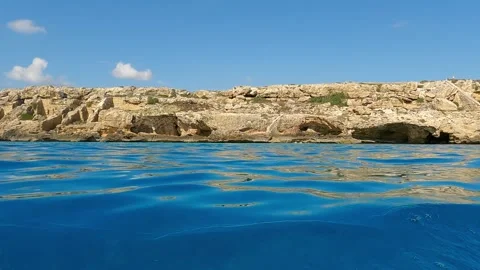 Extreme low-angle sea-level view from sailing boat of favignana coastline Stock Footage 278943004